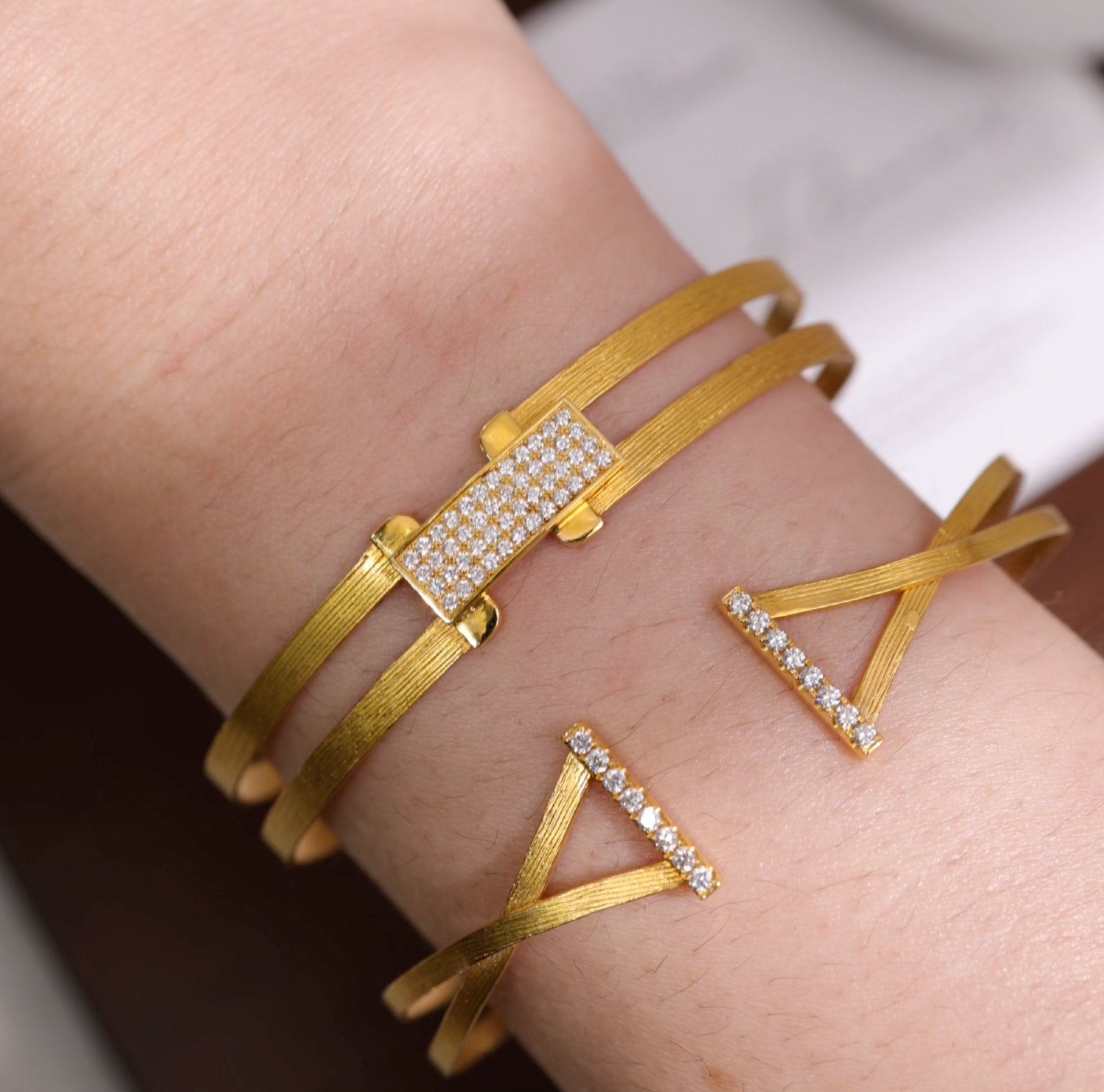 18K gold open-ended diamond bangle with hand-hammered texture from JewelryandStore