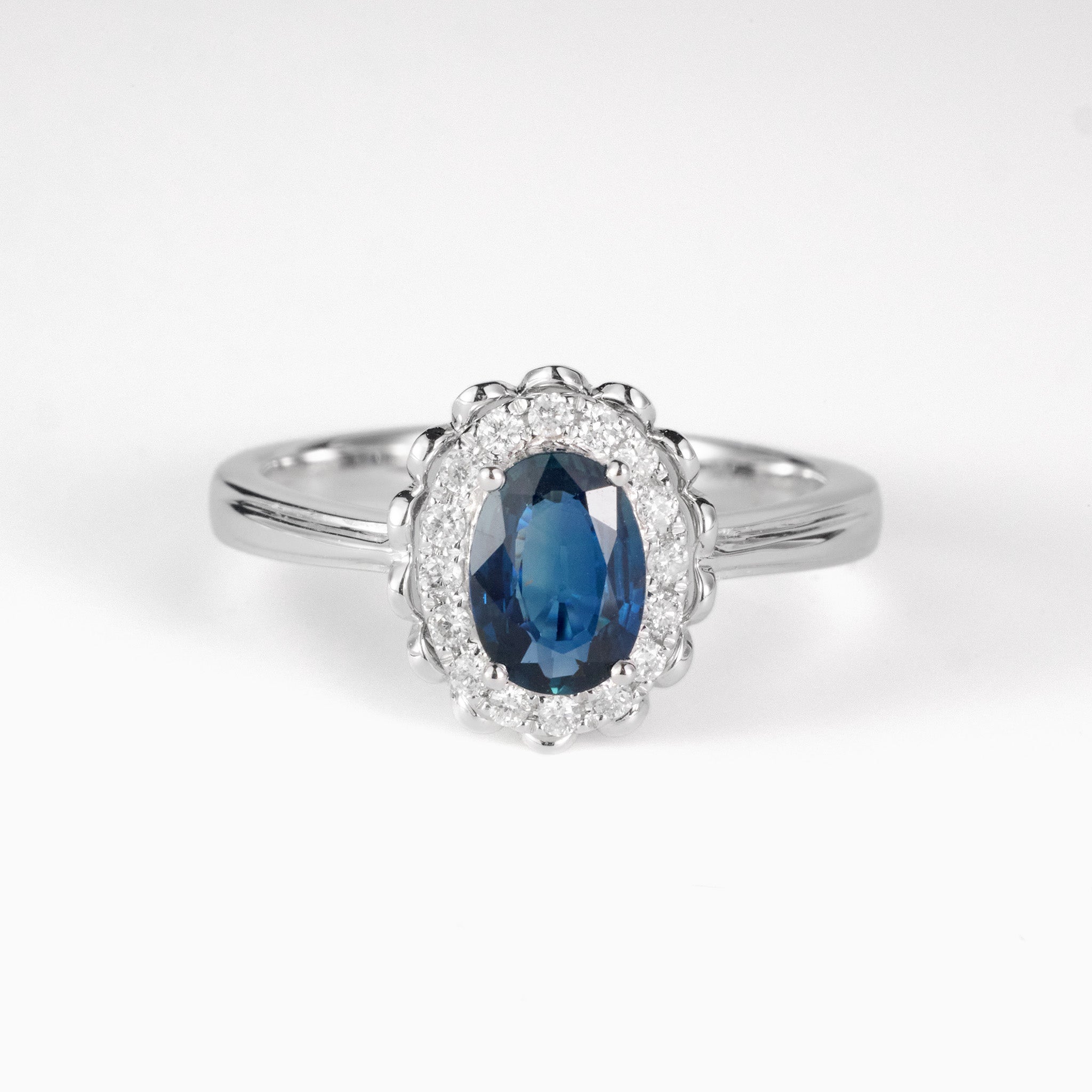 0.79ct. Elegant Oval Natural Blue Sapphire Diamond Halo Ring in 18K White Gold - JewelryAndStore