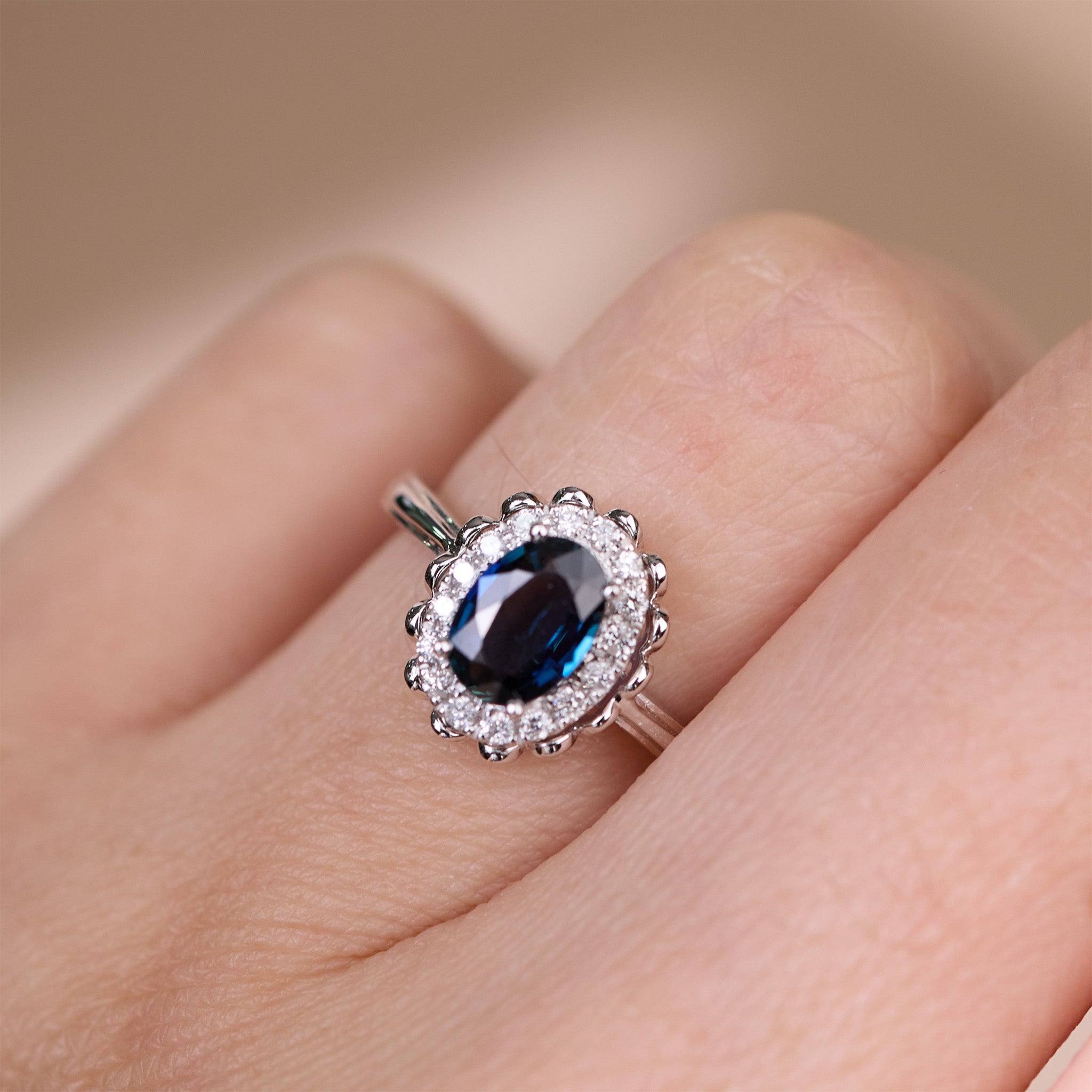 0.79ct. Elegant Oval Natural Blue Sapphire Diamond Halo Ring in 18K White Gold - JewelryAndStore
