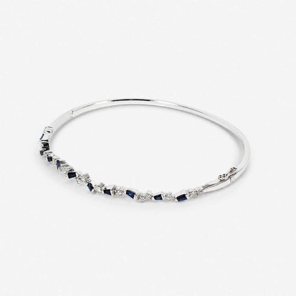 Natural Blue Sapphire and Diamond Asymmetric Wave Cluster Bangle in 18K White Gold - JewelryandStore