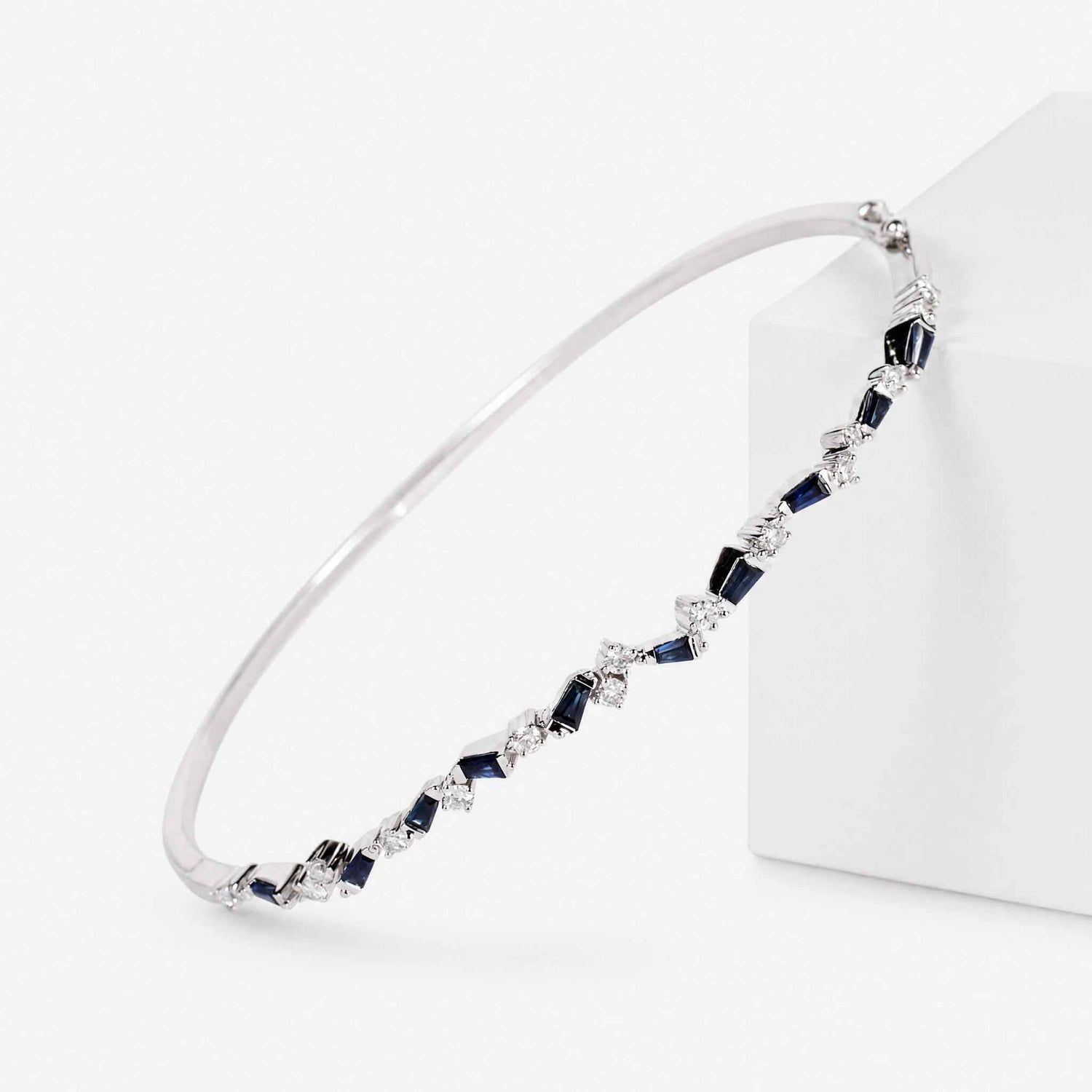 Natural Blue Sapphire and Diamond Asymmetric Wave Cluster Bangle in 18K White Gold - JewelryandStore