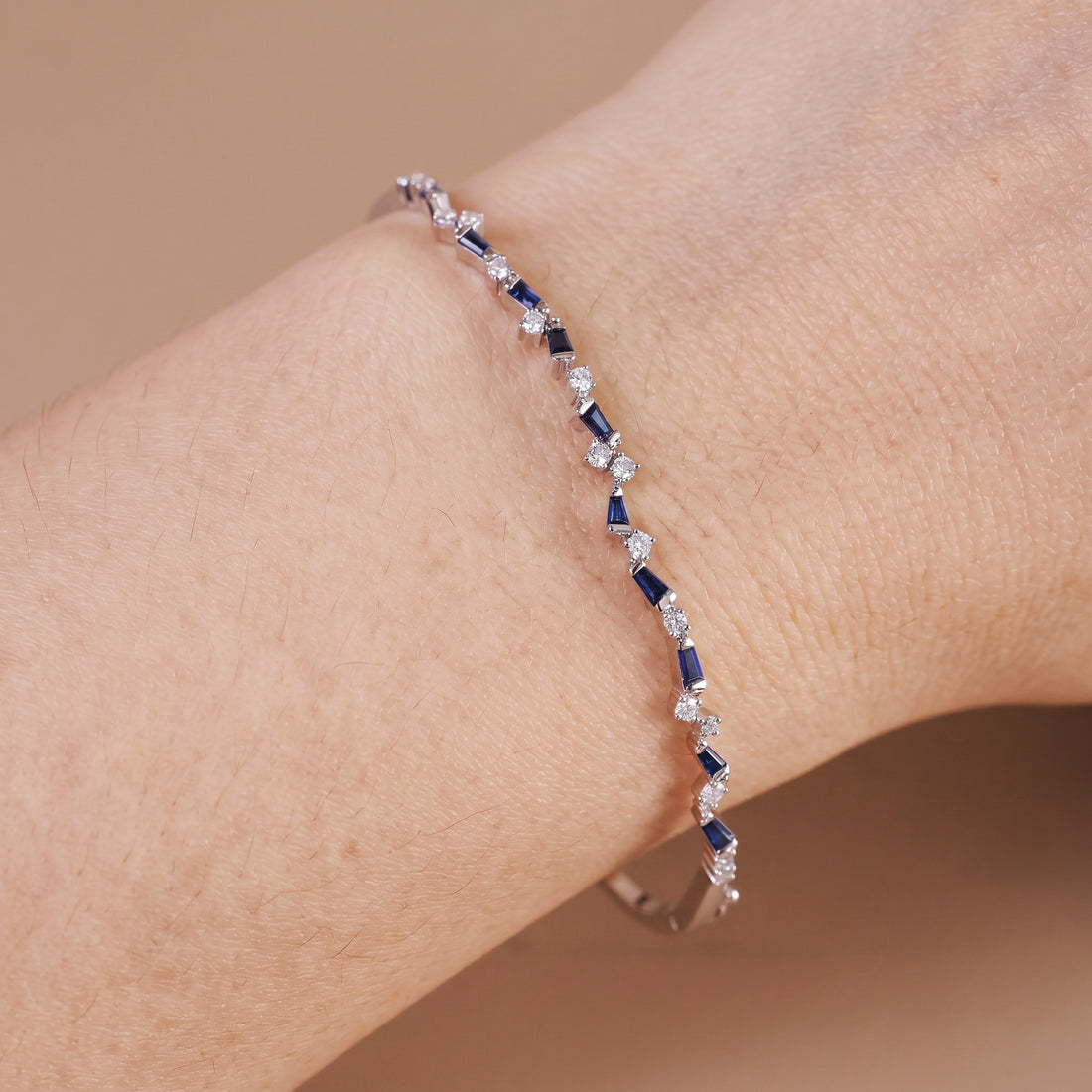 Natural Blue Sapphire and Diamond Asymmetric Wave Cluster Bangle in 18K White Gold - JewelryAndStore