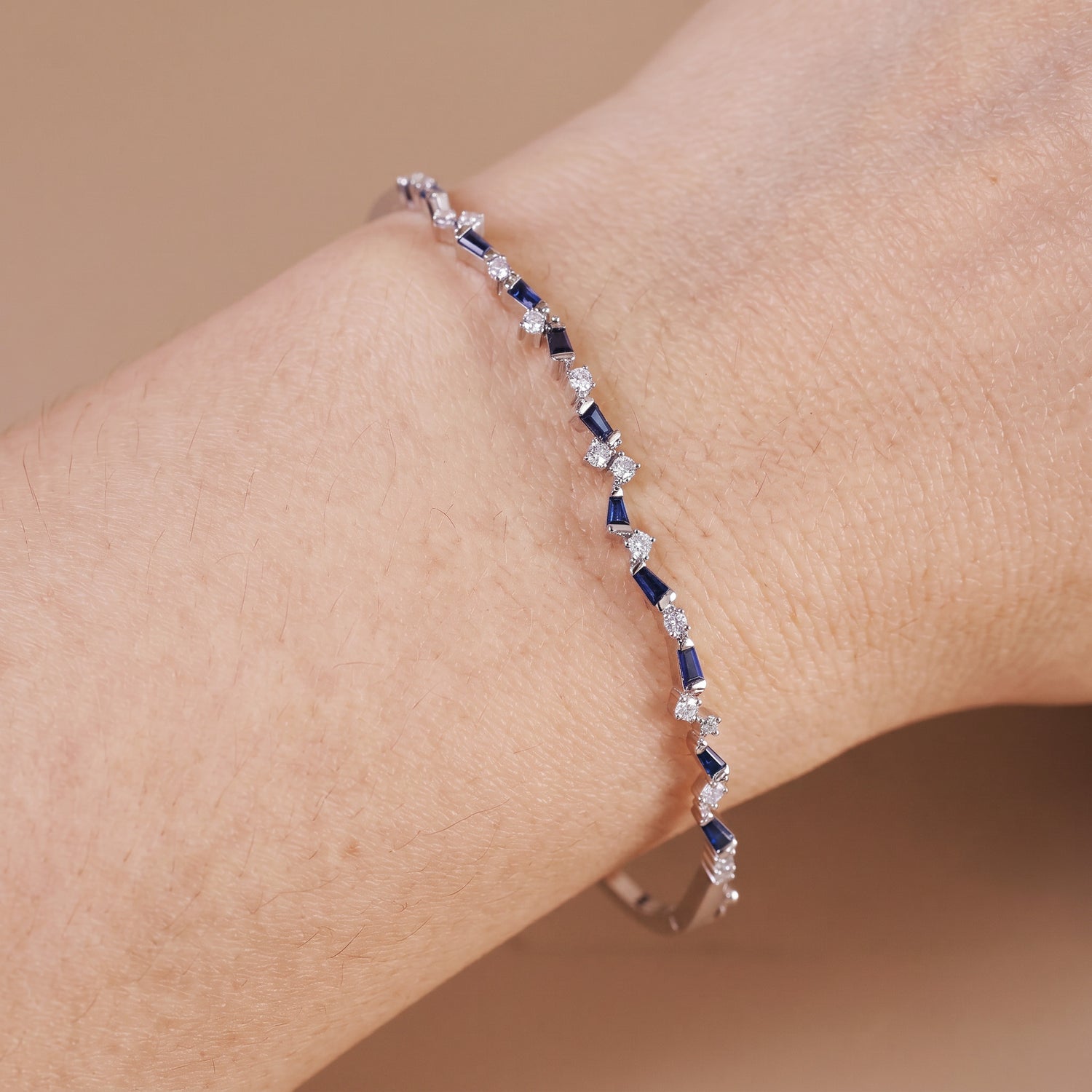Natural Blue Sapphire and Diamond Asymmetric Wave Cluster Bangle in 18K White Gold - JewelryAndStore