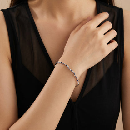 Natural Blue Sapphire and Diamond Asymmetric Wave Cluster Bangle in 18K White Gold - JewelryAndStore